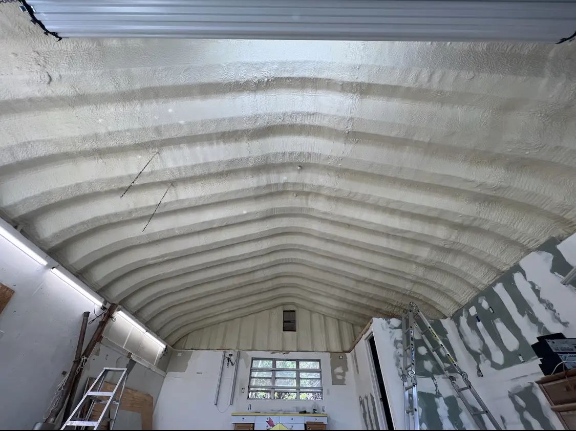 Spray polyurethane foam applied to the underside of a metal roof deck in Grayson